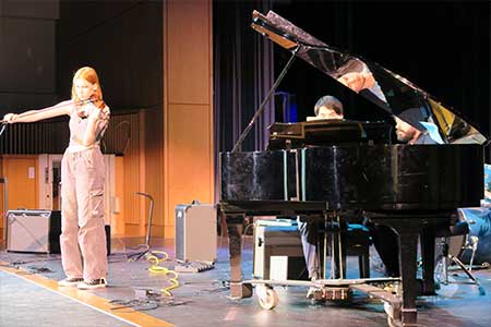 Somerstars student on violin and on piano during talent contest