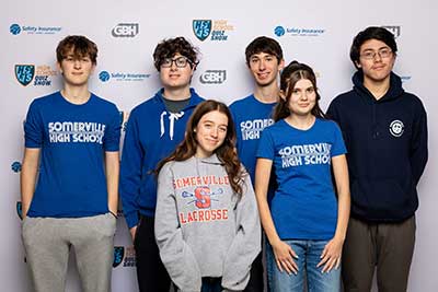 SHS Trivia team stands in front of WGBH High School Quiz show background