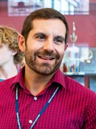 Photo of Mr. DiPietro in halls, smiling