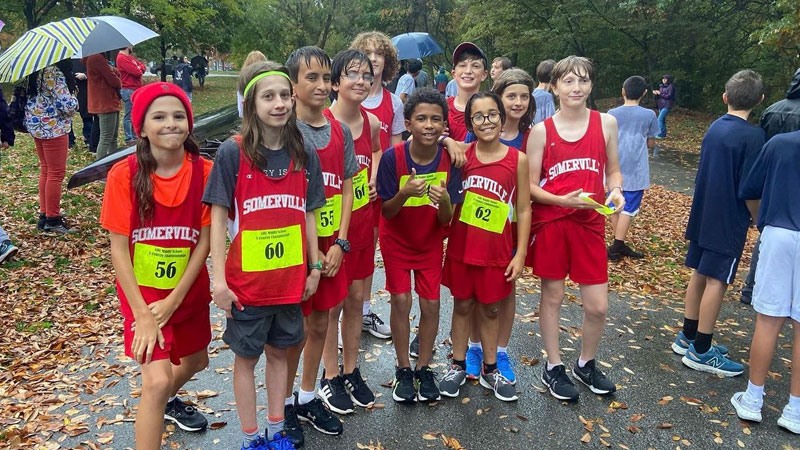 Middle Grades Cross Country Team photo at a meet