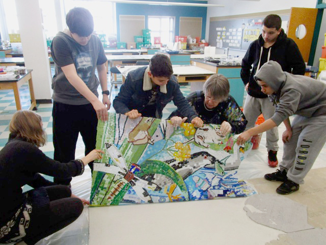 Students and David Fichter working on mural