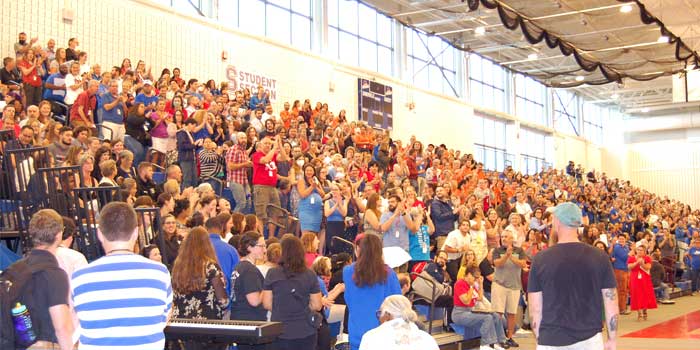 Photo of district educators and staff cheering for WHCIS staff at convocation