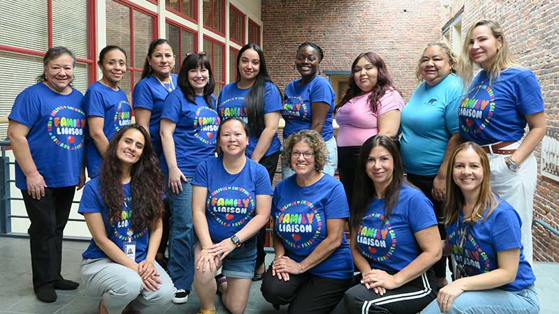 SFLC Liaisons in front of a stair case