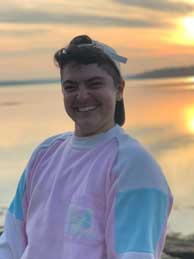 Photo of Mr. Timmins at beach at sunset, smiling