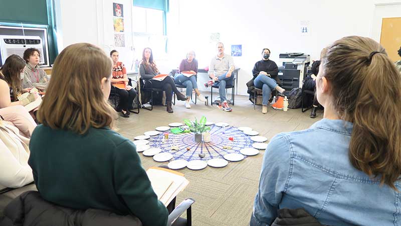Educators sit in a circle for discussion
