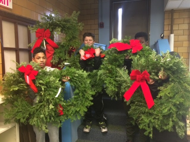 Students holding wreaths
